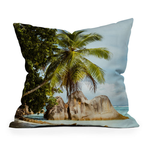 Pita Studios Palm tree bending over the sea Throw Pillow