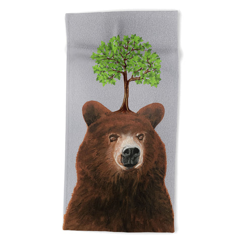 Coco de Paris A brown bear with a tree Beach Towel