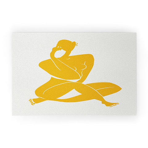 Little Dean Nude sitting in yellow Welcome Mat