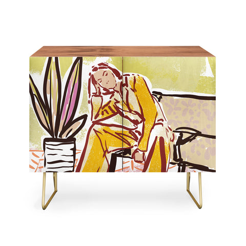 DESIGN d´annick Woman sitting on sofa Credenza