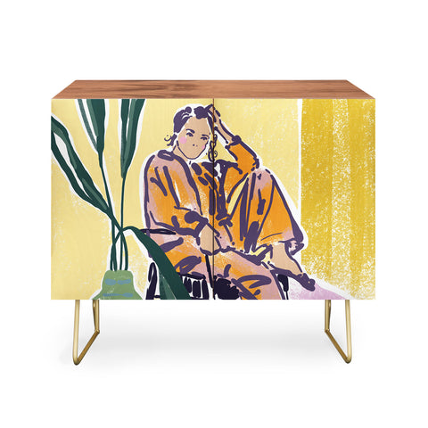 DESIGN dannick Woman wearing yellow pajamas Credenza