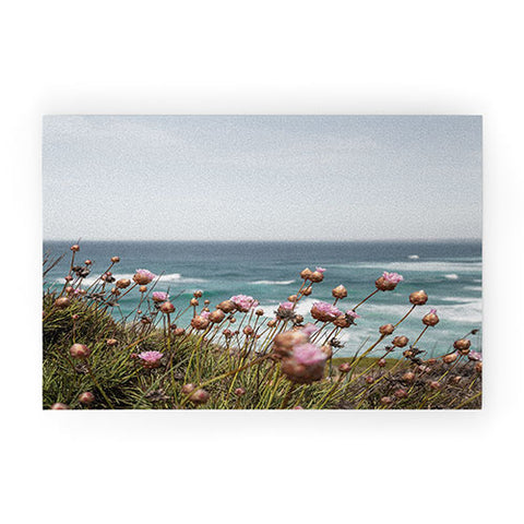 Henrike Schenk - Travel Photography Pink Flowers by the Ocean Welcome Mat