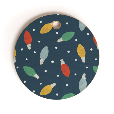 Little Arrow Design Co christmas light on blue Cutting Board Round