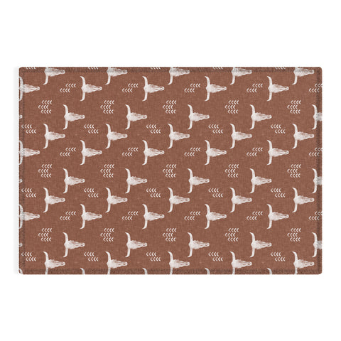 Little Arrow Design Co cow skulls on rust Outdoor Rug