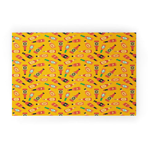 Little Arrow Design Co hot sauce bottles on yellow Welcome Mat