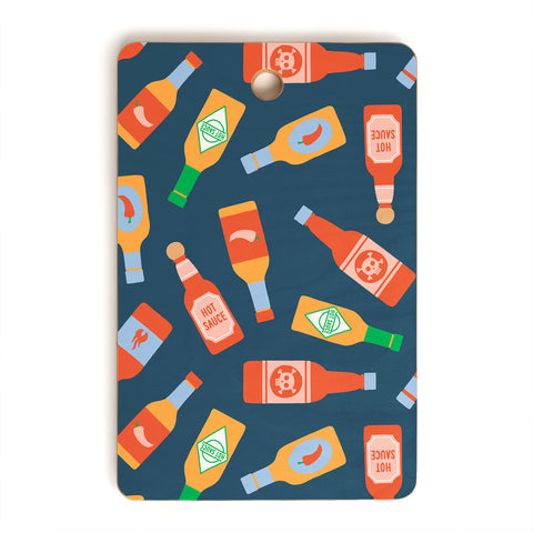Little Arrow Design Co hot sauces bottles on blue Cutting Board Rectangle