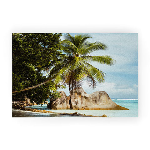 Pita Studios Palm tree bending over the sea Welcome Mat