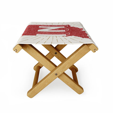 Society6 Design Studio state abbreviation prints in crimson cream Folding Stool