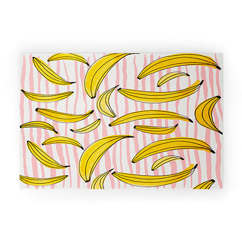 Angela Minca Doodle bananas on pink stripes Welcome Mat