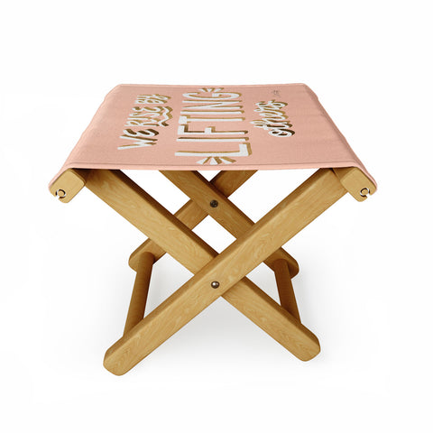 Cat Coquillette We Rise By Lifting Others Blush and Gold Folding Stool