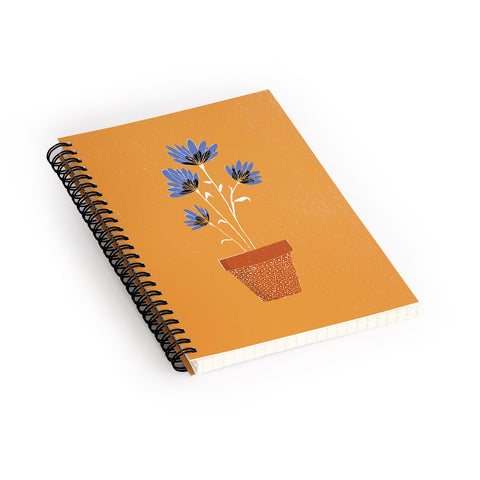 justin shiels blue flowers on orange background Spiral Notebook