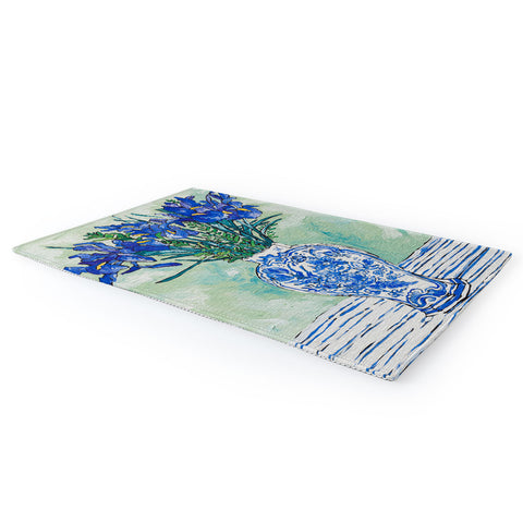 Lara Lee Meintjes Iris Bouquet in Chinoiserie Vase on Blue and White Striped Tablecloth on Painterly Mint Green Area Rug
