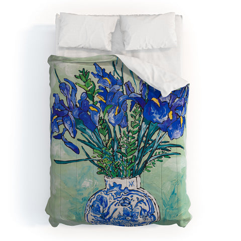 Lara Lee Meintjes Iris Bouquet in Chinoiserie Vase on Blue and White Striped Tablecloth on Painterly Mint Green Comforter