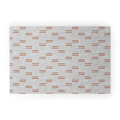 Little Arrow Design Co double dash rust on greige Welcome Mat