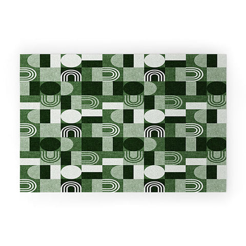 Little Arrow Design Co geometric patchwork green Welcome Mat