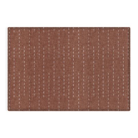 Little Arrow Design Co running stitch rust Outdoor Rug