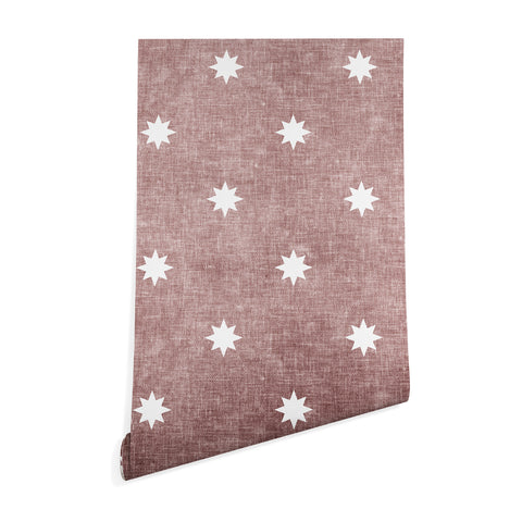 Little Arrow Design Co stars on mauve Wallpaper