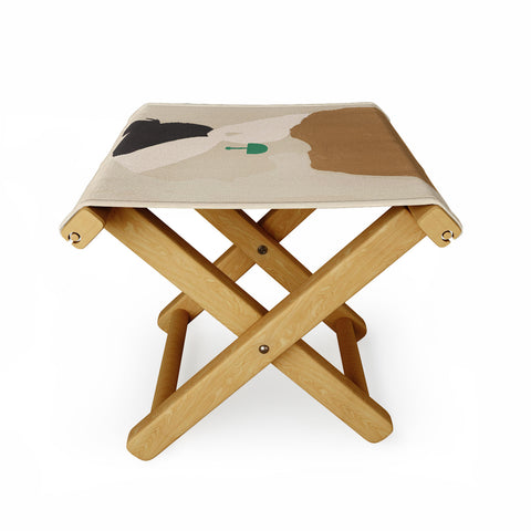 Megan Galante Minimalist Woman with Green Ea Folding Stool
