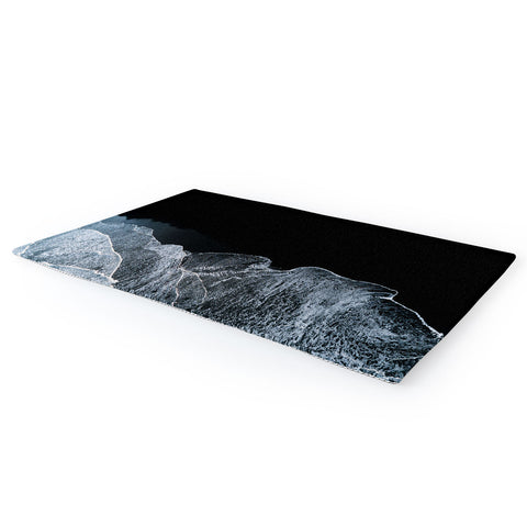 Michael Schauer Waves on a black sand beach Area Rug
