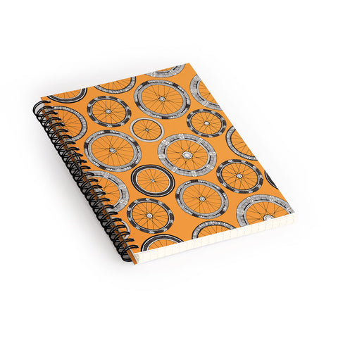 Sharon Turner bike wheels amber Spiral Notebook