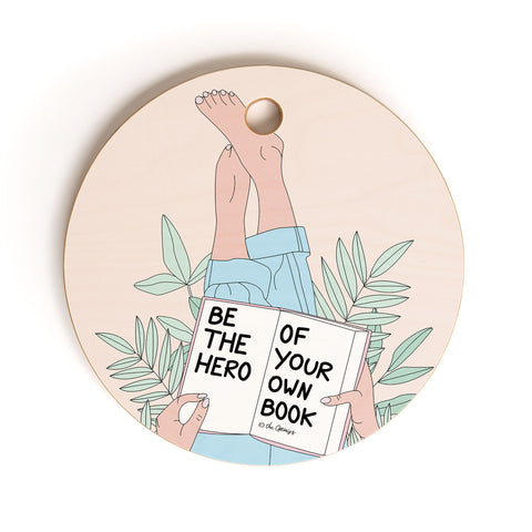 The Optimist Be The Hero Of Your Own Book Cutting Board Round